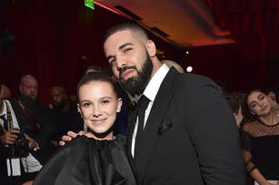 Millie Bobby Brown and Drake posing together at an event, both dressed in formal attire