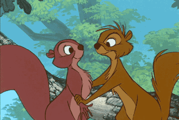 Animated characters Timon and Pumbaa dancing in a scene from The Lion King