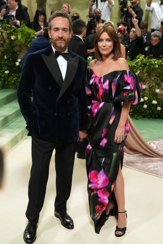 Matthew Macfadyen and Keeley Hawes posing, man in a velvet suit, woman in a floral off-shoulder dress