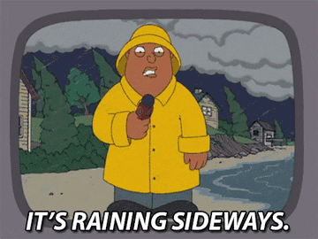 Animated character Ollie Williams reporting heavy rain with text &quot;IT'S RAINING SIDEWAYS.&quot;