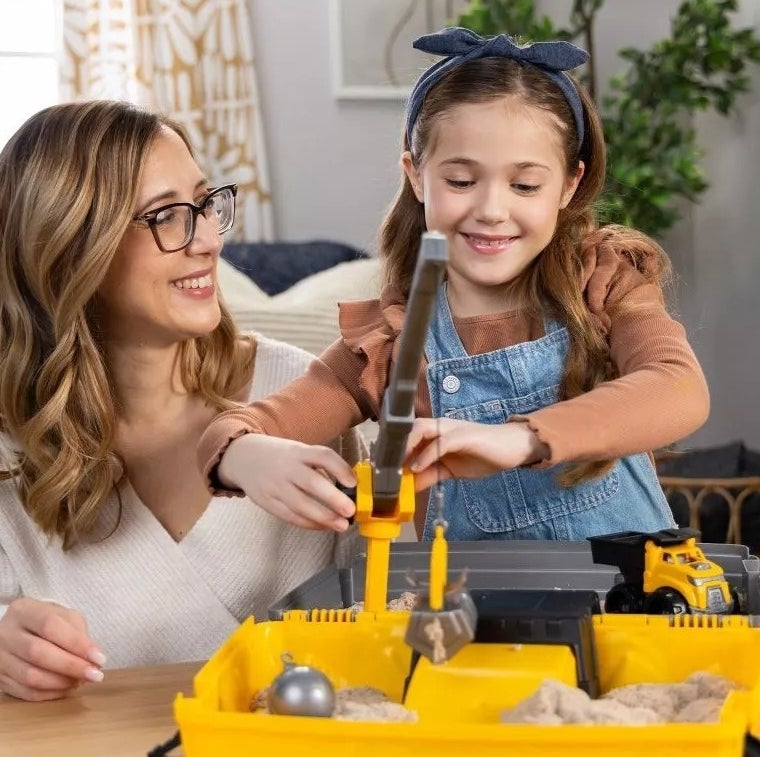 Adult and child engaging with a toy construction set