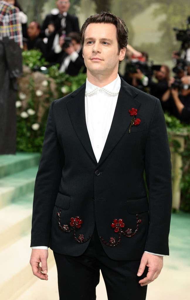 Jonathan Groff in elegant suit with floral embroidery on the pockets at a glamorous event