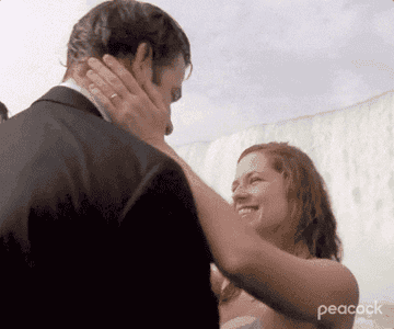 Two people embracing and smiling at Niagara Falls