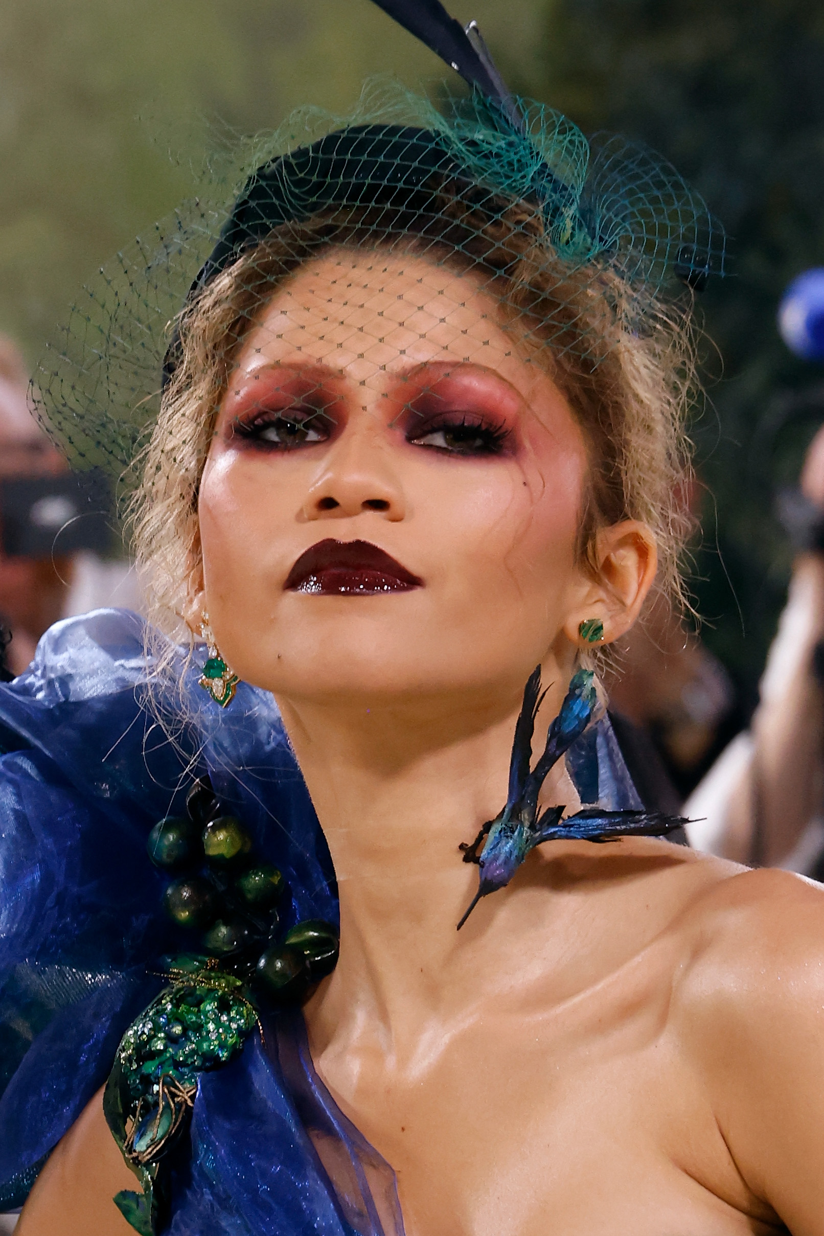 Zendaya with avant-garde makeup and embellished headpiece at a themed event