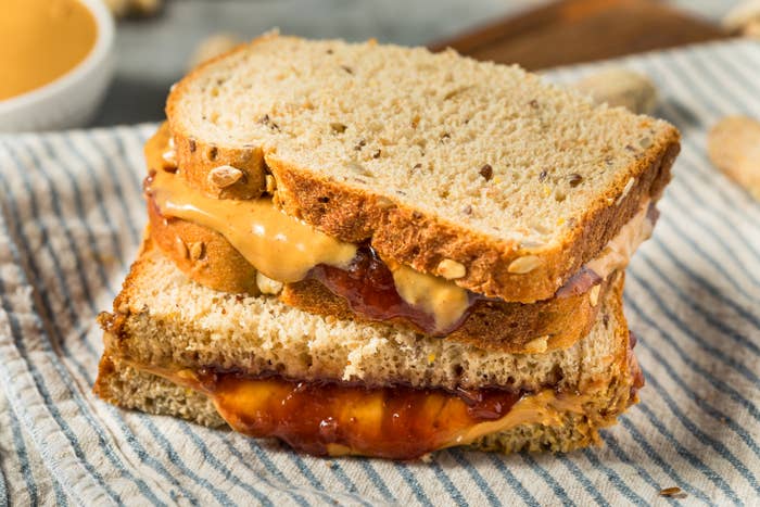Peanut butter and jelly sandwich on a striped napkin