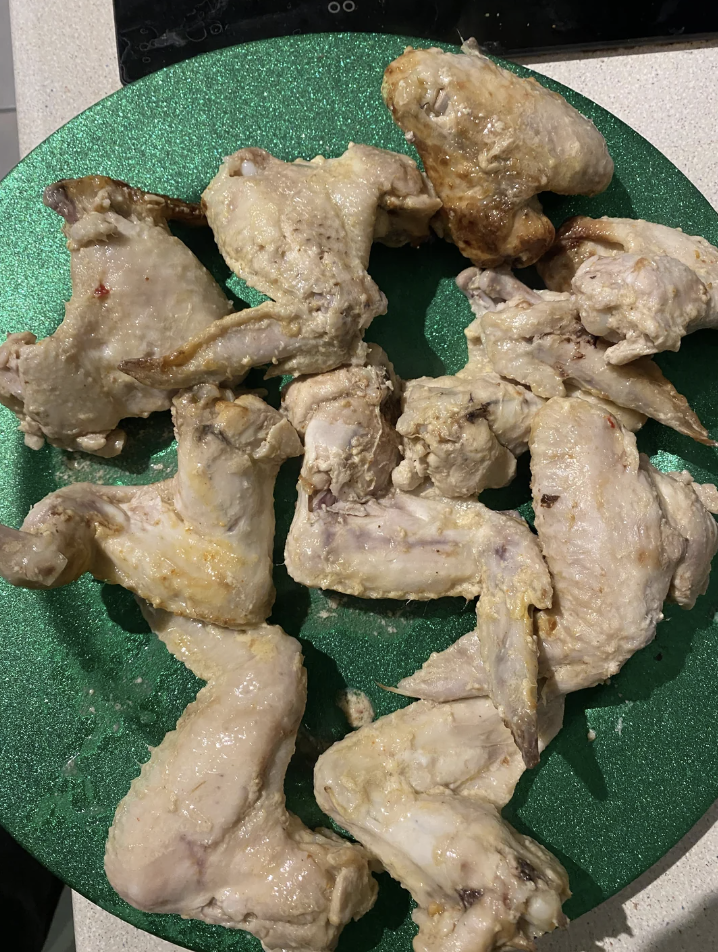 A plate of cooked chicken pieces
