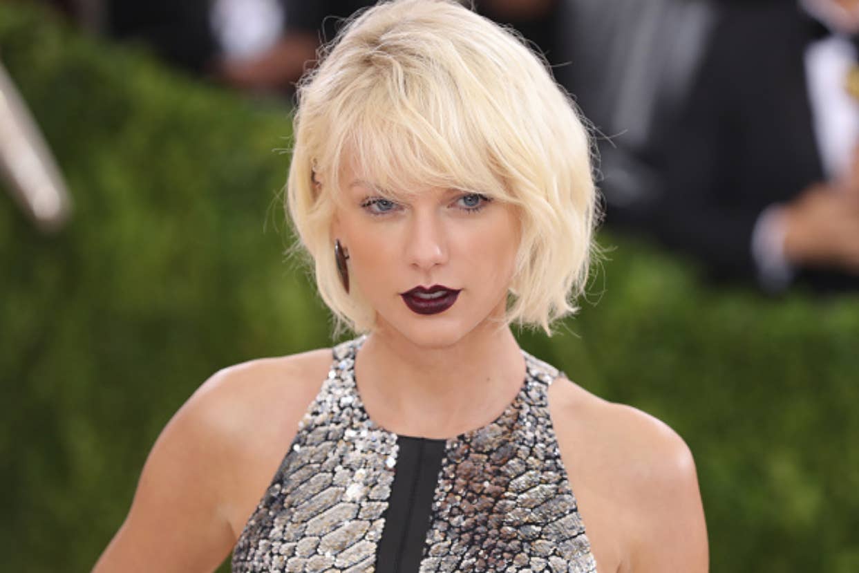 Taylor Swift wearing a silver sequined dress at an event