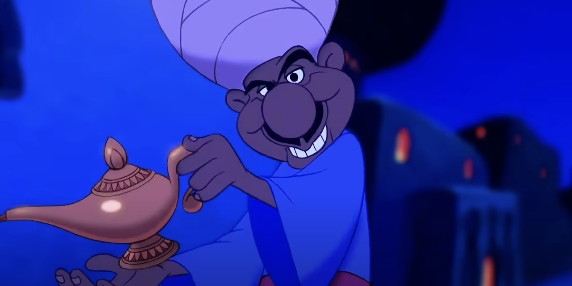Mercent from Aladdin grinning as he holds the magic lamp