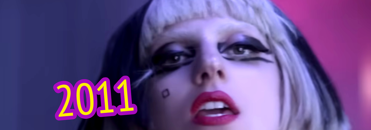 Lady Gaga with bold makeup and a bob haircut, text "2011" displayed