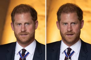 Prince Harry in a navy suit with a striped tie, looking serious