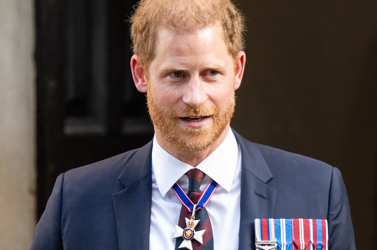 Prince Harry in a dark suit with medals, attending a formal event