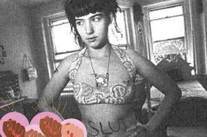 Kathleen Hanna poses with biniki and "slut" written over her belly butto with three animated hands in the corner on different brown shades over pink bubbles. 
