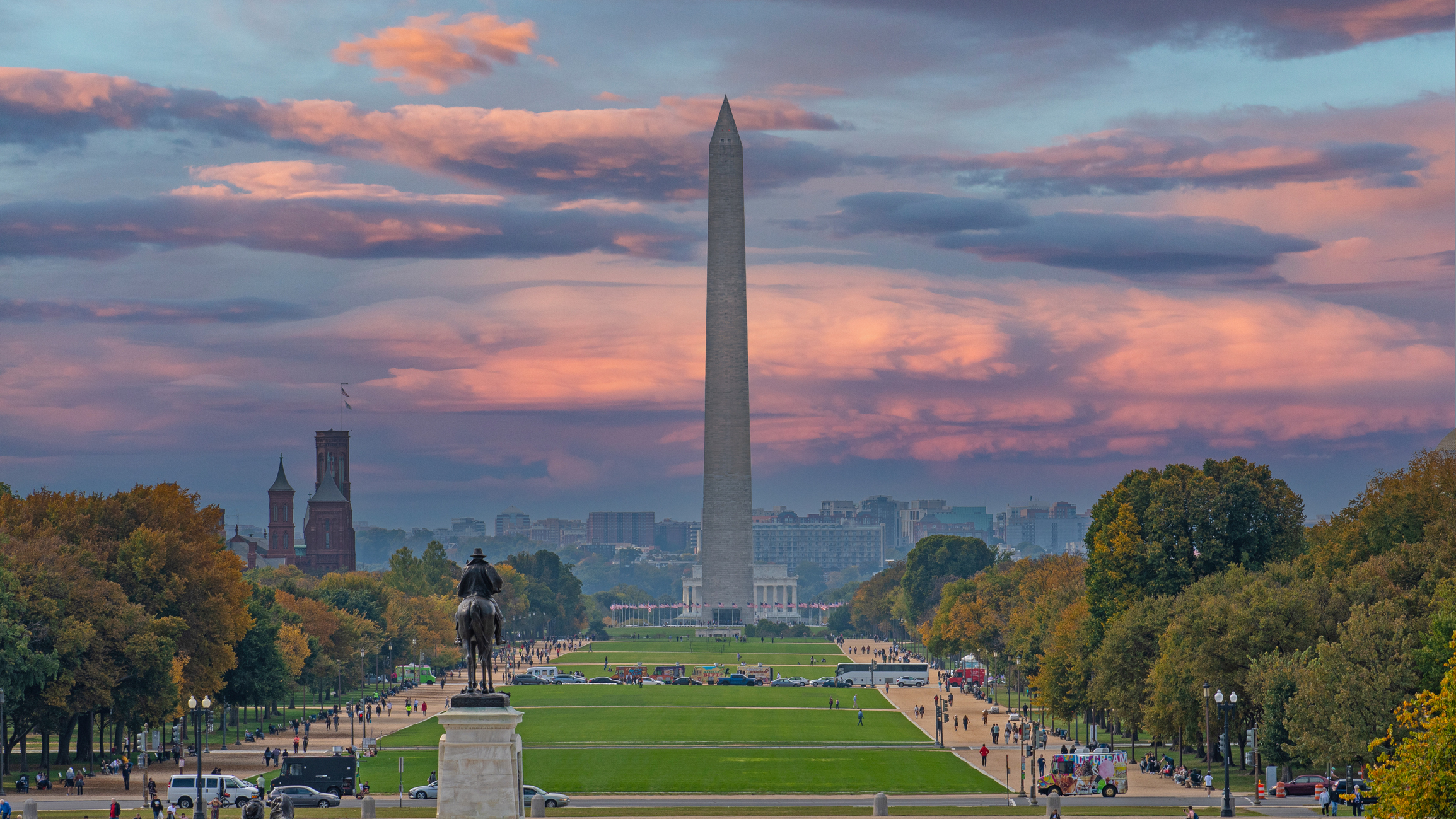 Washington Monument seen from the National Mall at dusk with clear skies and surrounding landscape