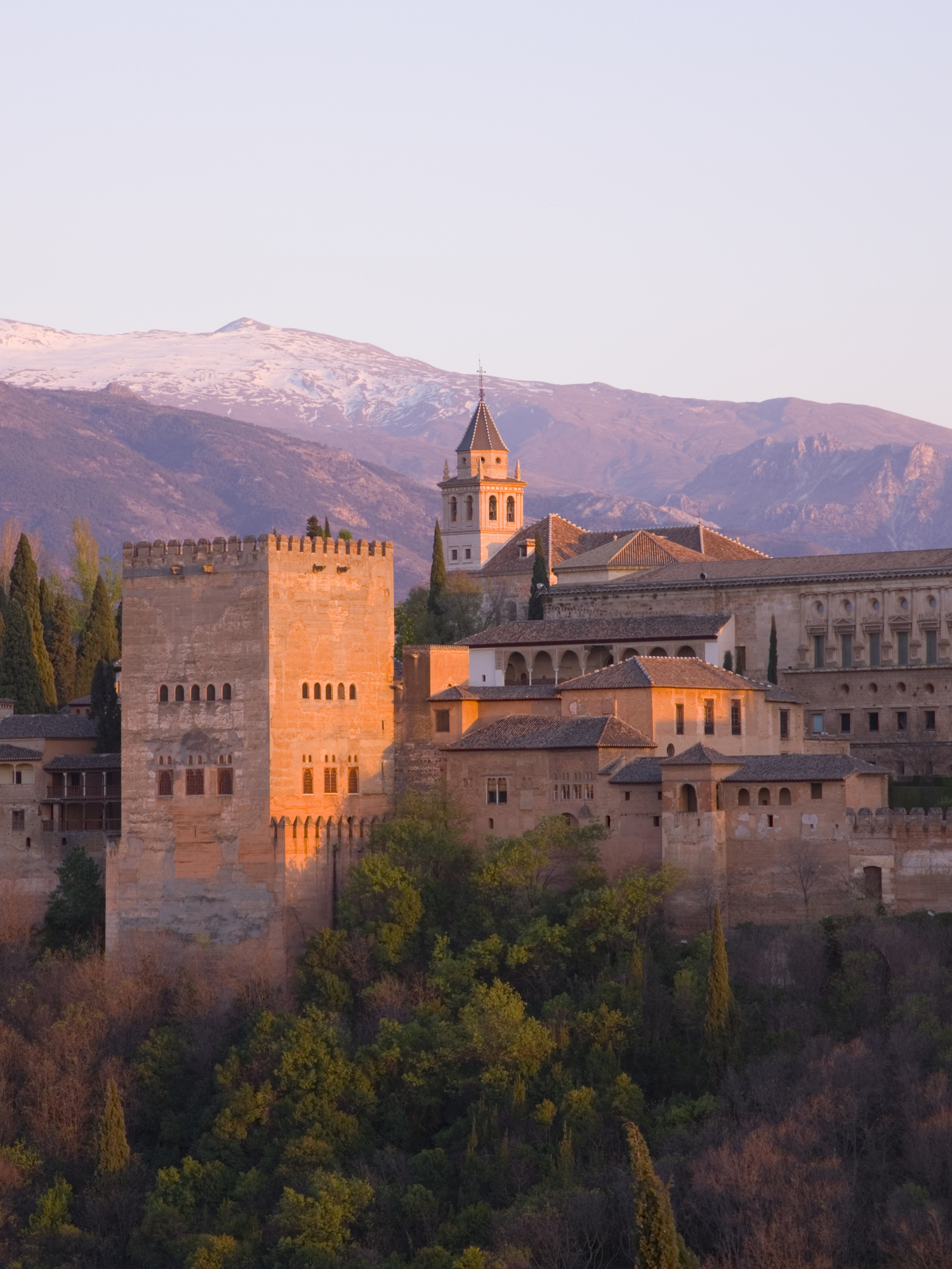 Sunset view of the Alhambra palace complex with the Sierra Nevada in the background