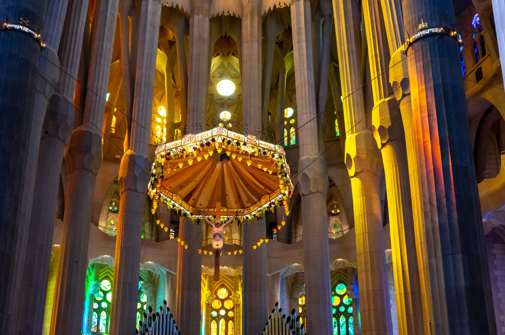 Interior of Sagrada Familia with ornate chandelier and stained glass windows