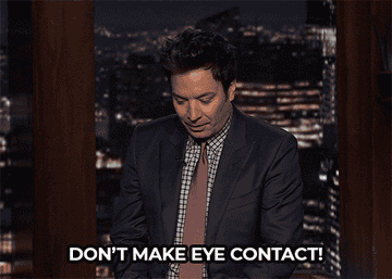 Person looking down with hand gesture, text overlay reads &quot;DON&#x27;T MAKE EYE CONTACT!&quot;
