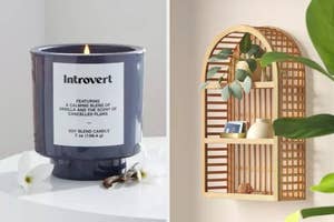 A candle labeled "Introvert" next to a shelf with decor items