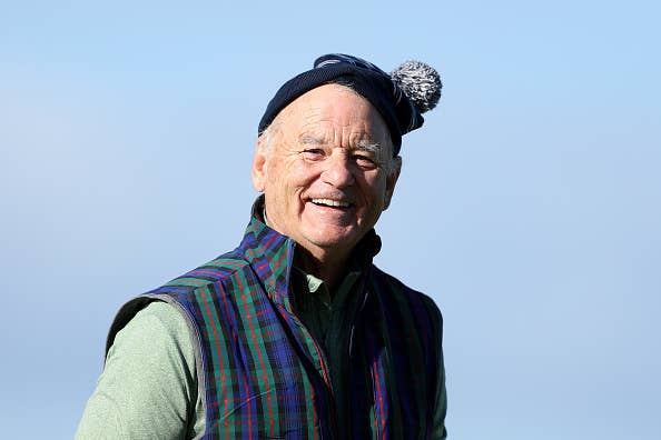 Smiling Bill Murray wearing a beanie and plaid vest outdoors