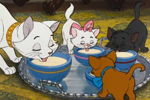 The cats from The Aristocats licking up milk