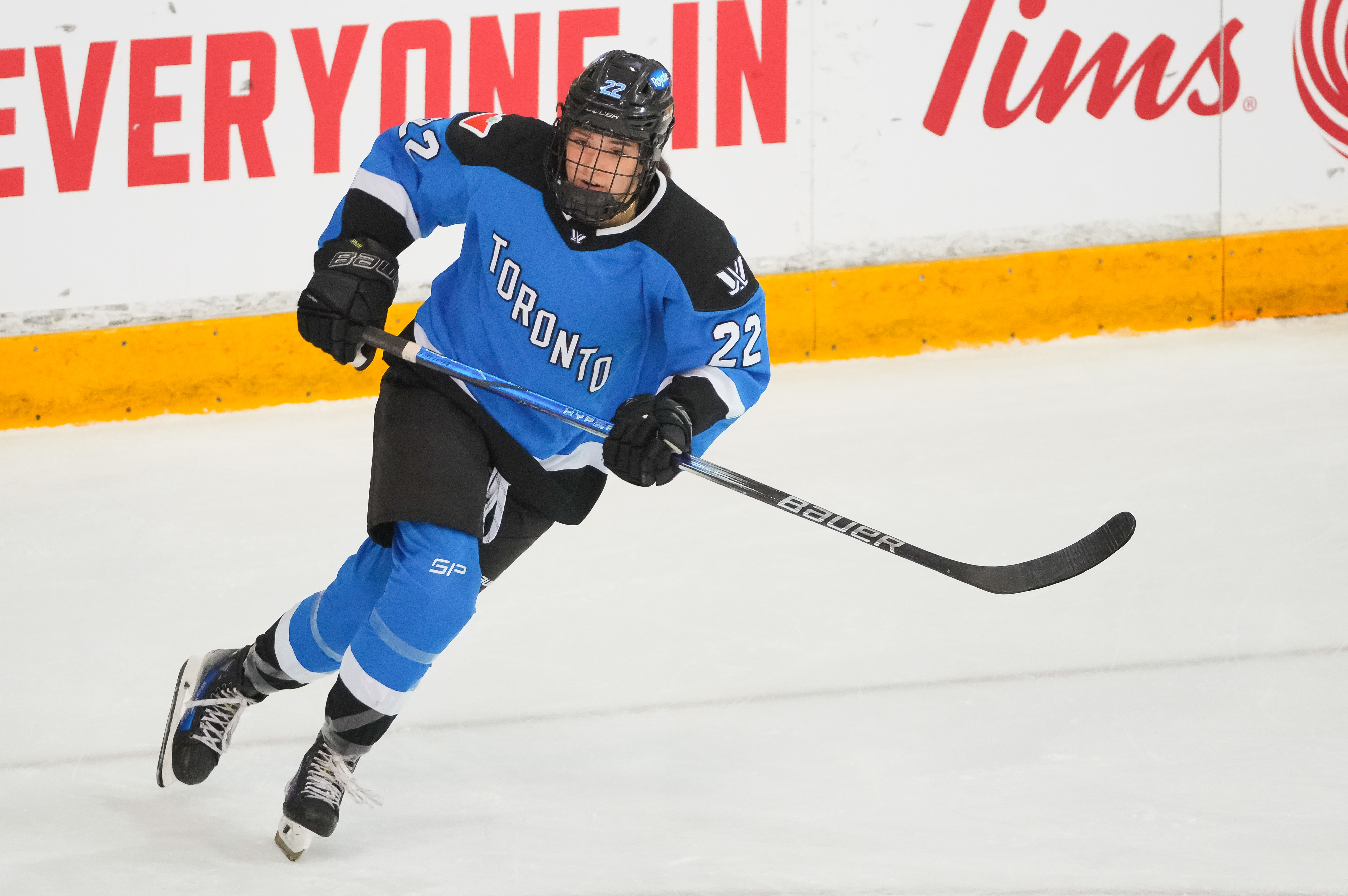 Hockey player in action during a game, wearing Toronto&#x27;s blue and white uniform, number 22