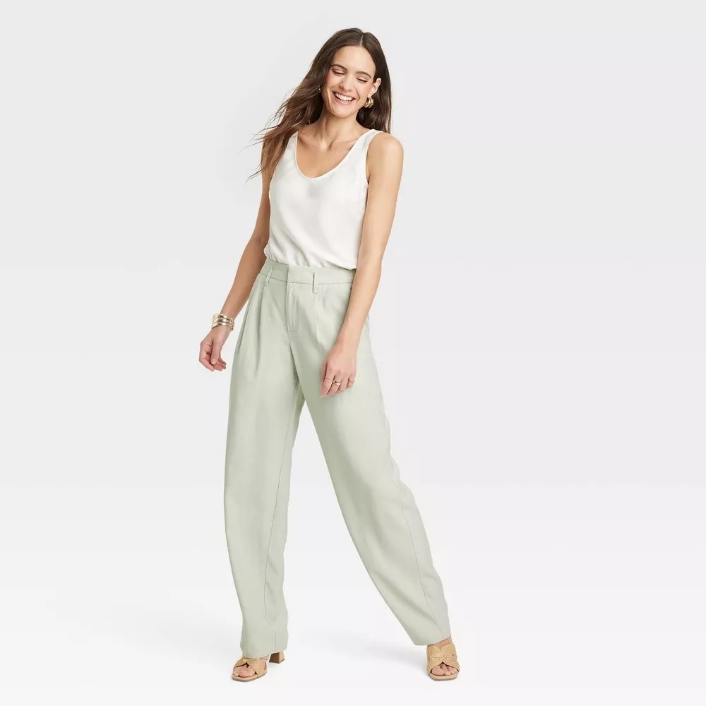 Model in green high-rise trousers
