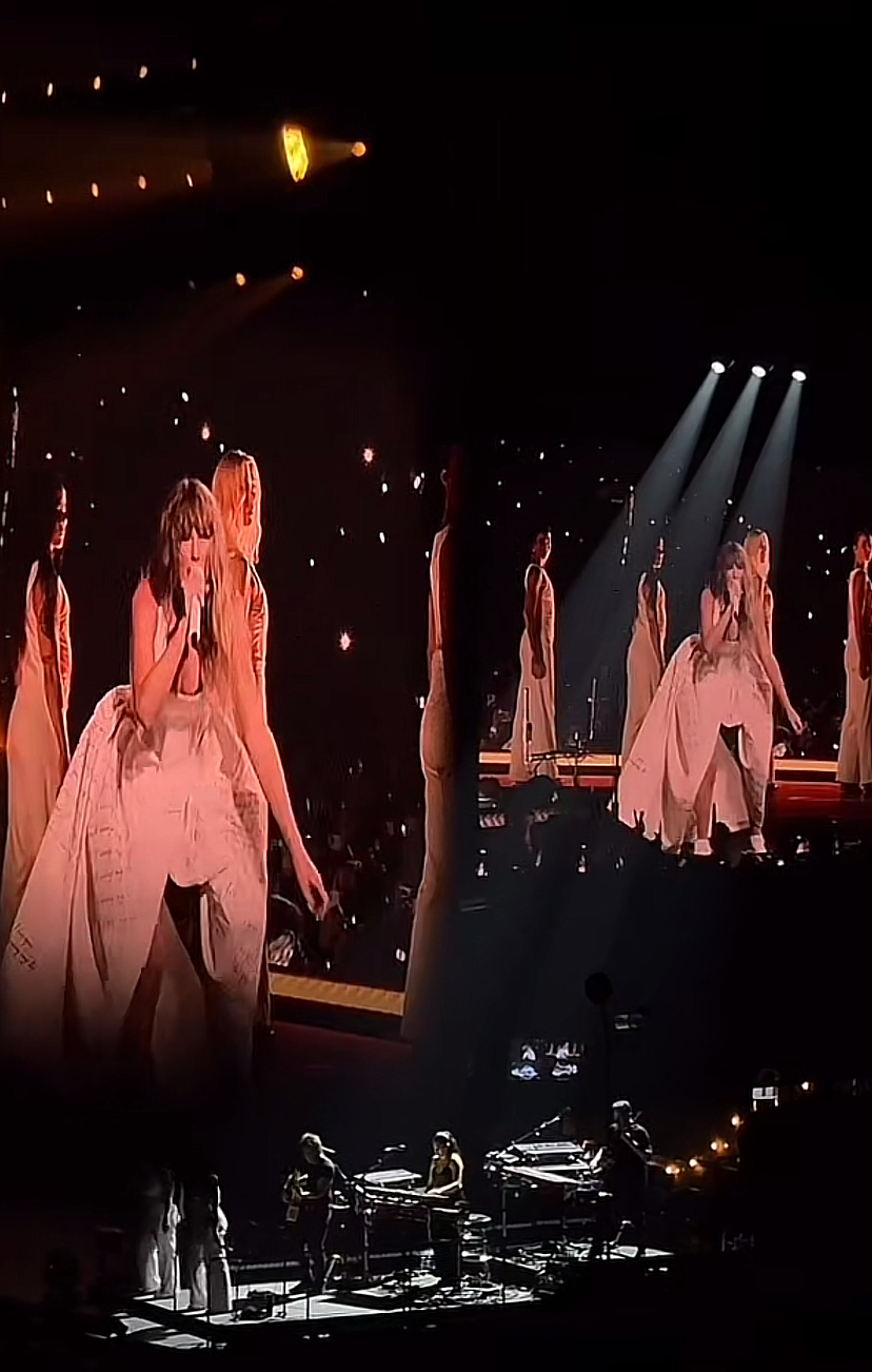 Taylor Swift performs on stage in a voluminous dress with backup singers in similar attire
