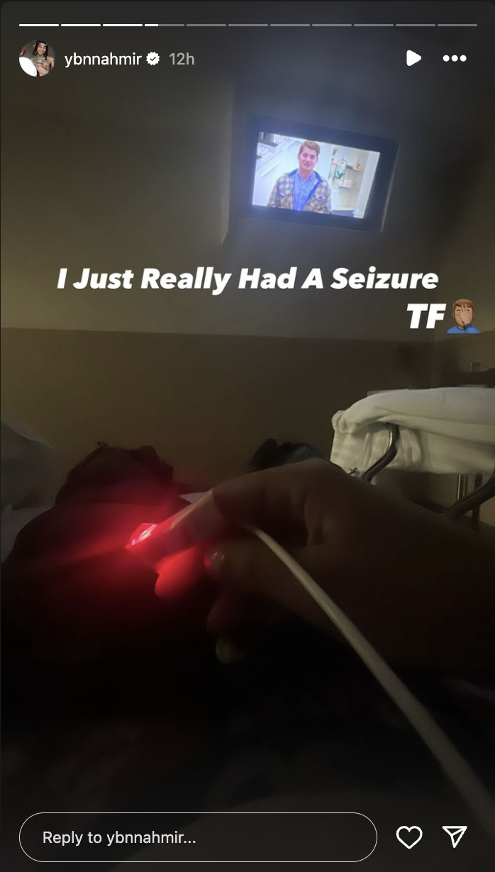 Person in hospital bed with pulse oximeter on finger, watching TV, text overlay &quot;I just really had A Seizure TF.&quot;