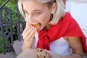Emma Chamberlain eating a chocolate chip cookie