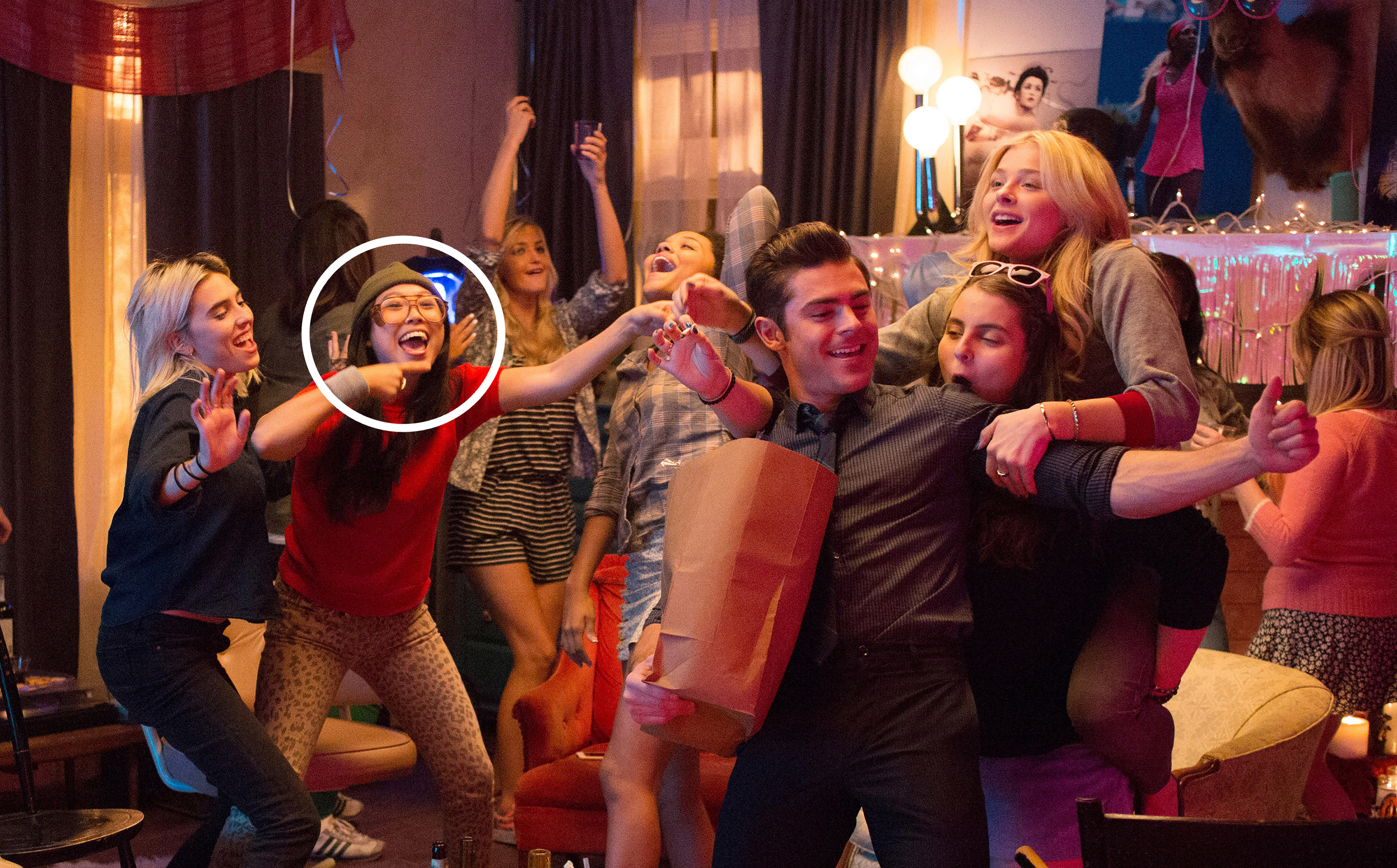 Group of people including Awkwafina, Zac Efron, Beanie Feldstein and Chloë Grace Moretz having fun at a party, dancing and smiling