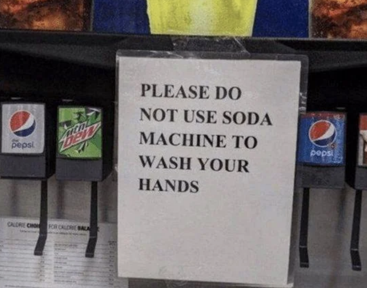 Sign reads &quot;PLEASE DO NOT USE SODA MACHINE TO WASH YOUR HANDS&quot; on a soda fountain machine