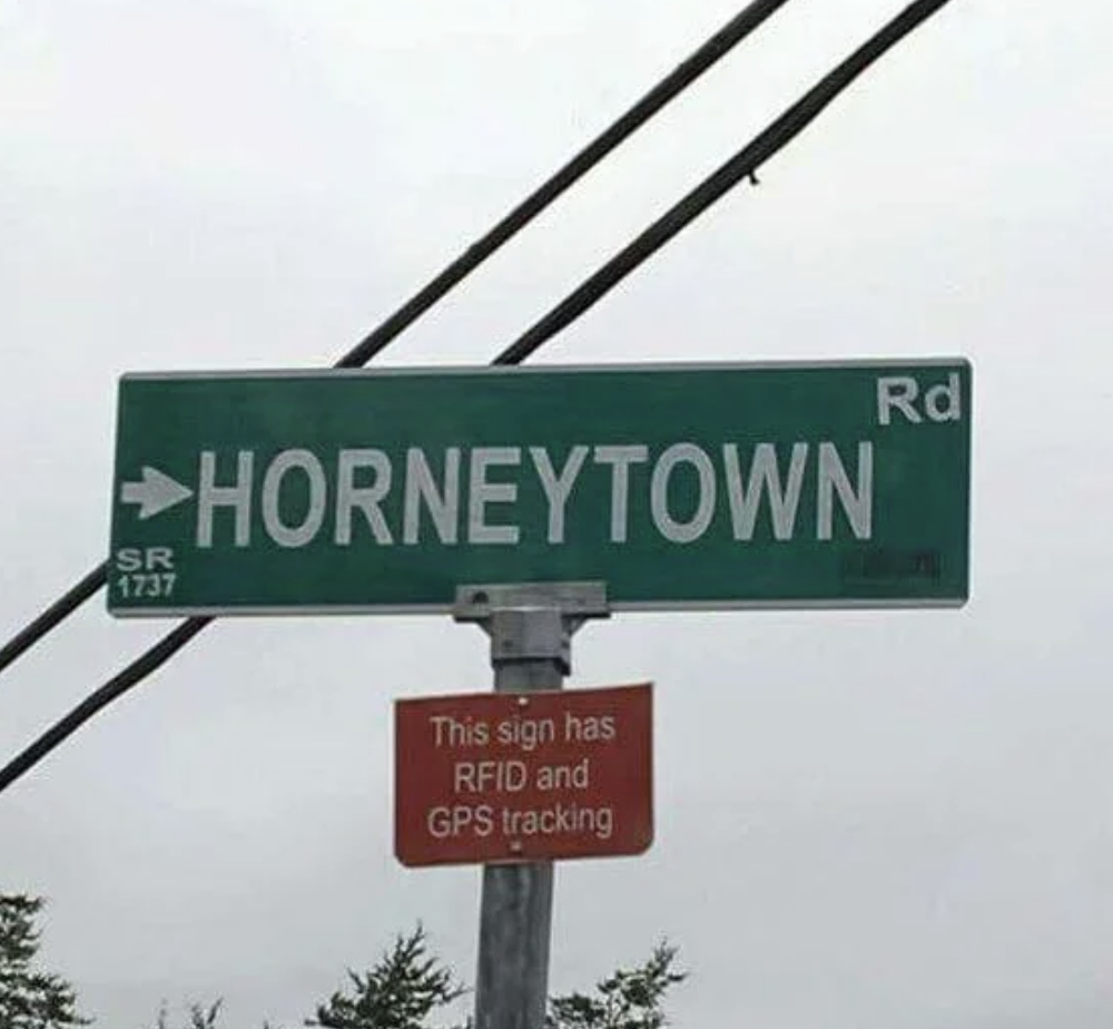 Street sign reading &quot;Horneytown Rd&quot; with additional sign below stating &quot;This sign has RFID and GPS tracking.&quot;