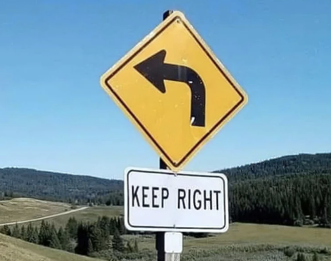 Traffic sign with a left arrow above a &quot;KEEP RIGHT&quot; sign, creating a contradictory message