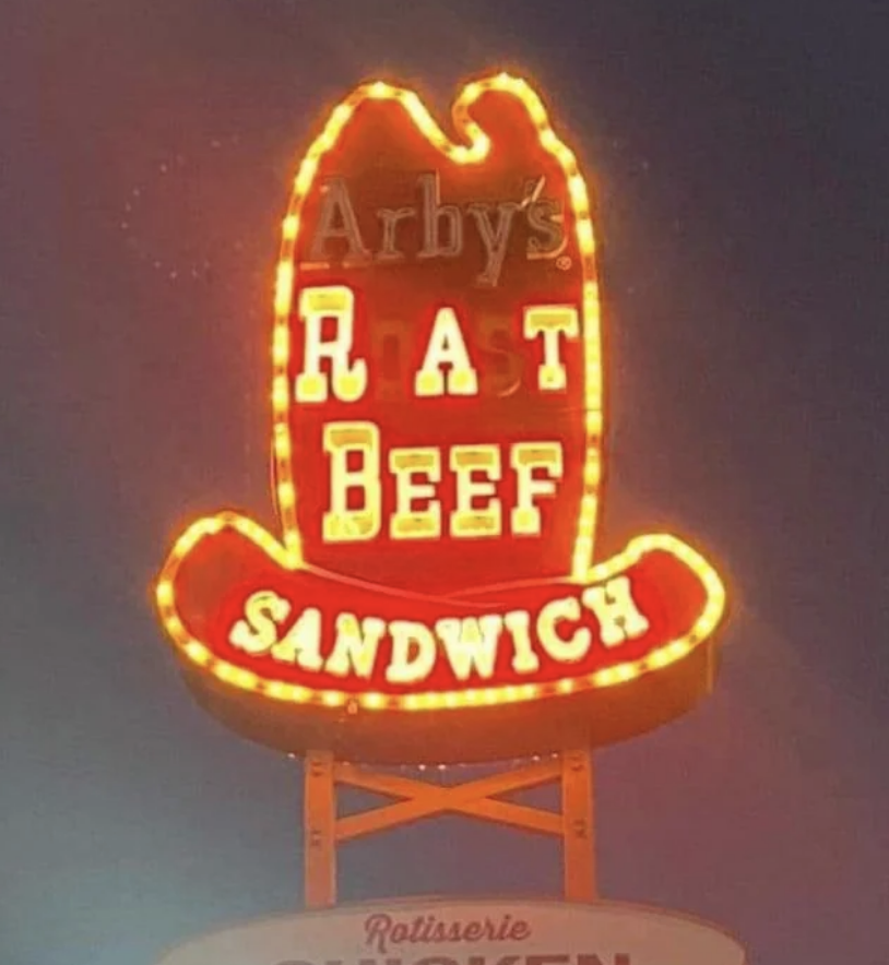 An Arby&#x27;s sign with some letters unlit reads &quot;RAT BEEF SANDWICH&quot; instead of the full brand name and product