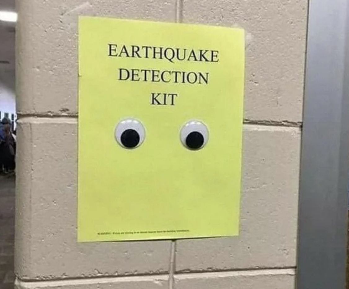 Paper with &quot;EARTHQUAKE DETECTION KIT&quot; text and two googly eyes attached