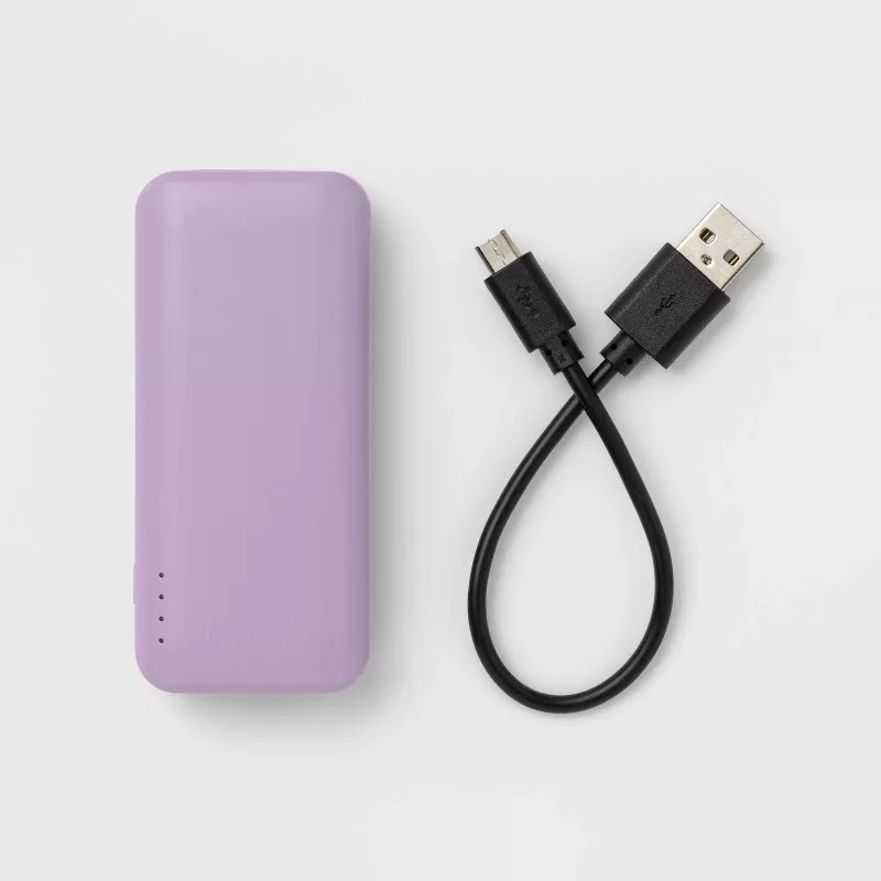 Purple portable power bank with a USB cable on a white background