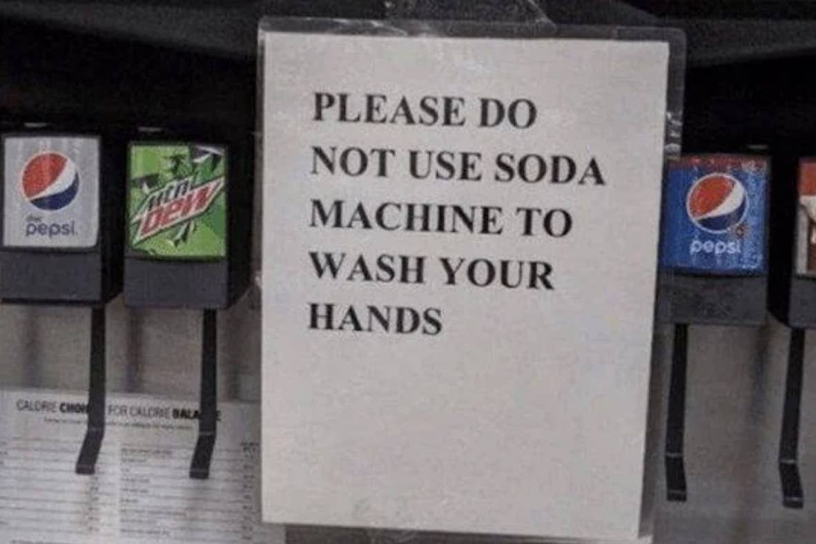 Sign reads "PLEASE DO NOT USE SODA MACHINE TO WASH YOUR HANDS" placed on a beverage dispenser