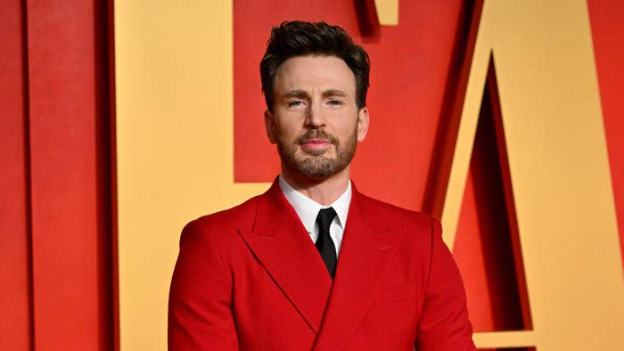 Chris Evans on the red carpet, wearing a stylish suit and tie