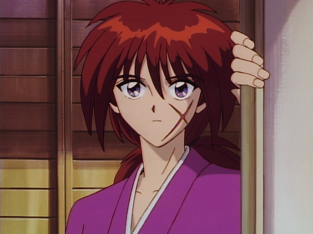 Kenshin Himura from "Rurouni Kenshin" stands pensively by a sliding wooden door, wearing a traditional robe and displaying his distinctive facial scar