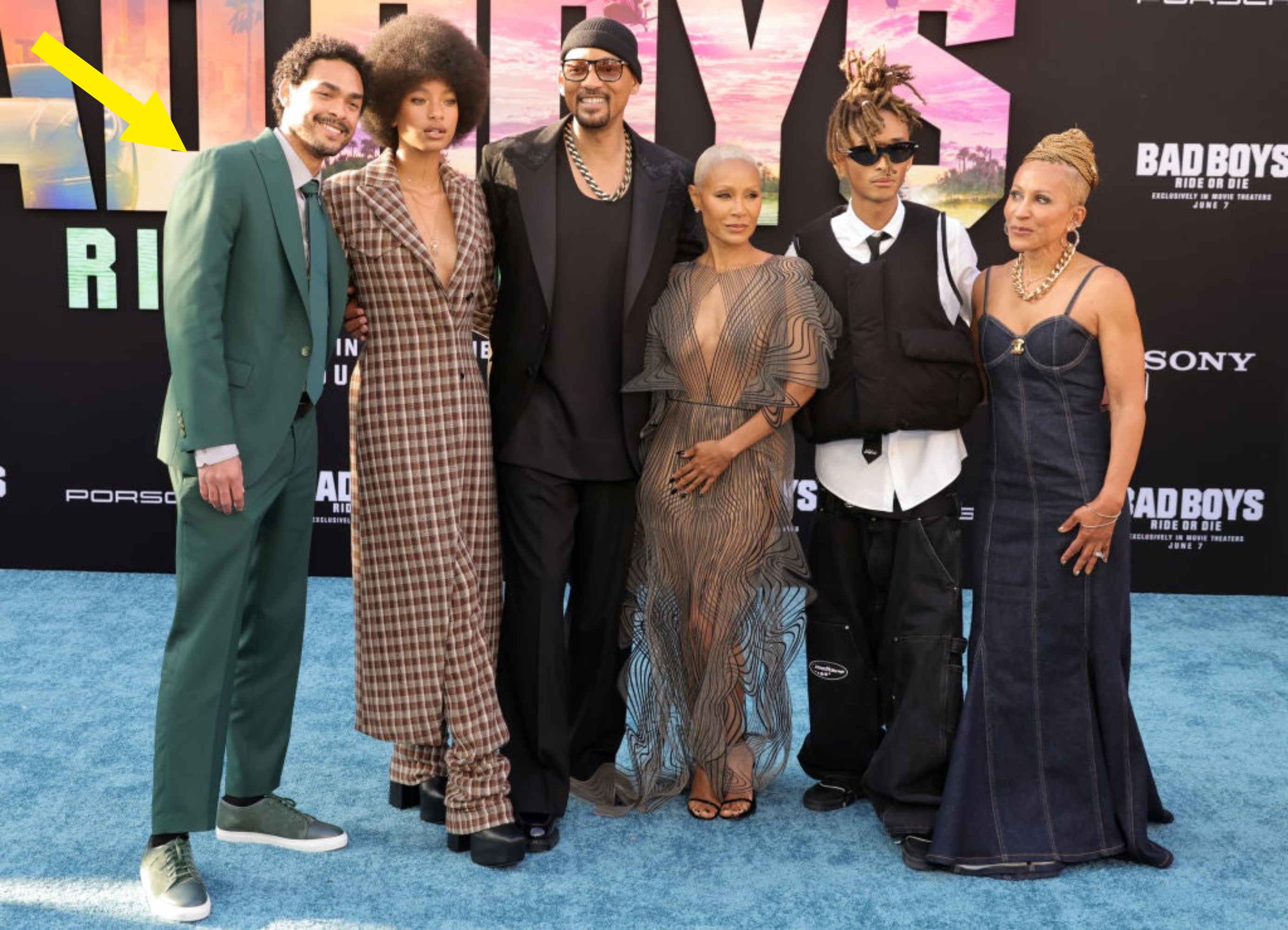 Will Smith, Jaden Smith, and family pose together in stylish outfits at a red carpet event for "Bad Boys for Life." They are dressed in designer attire