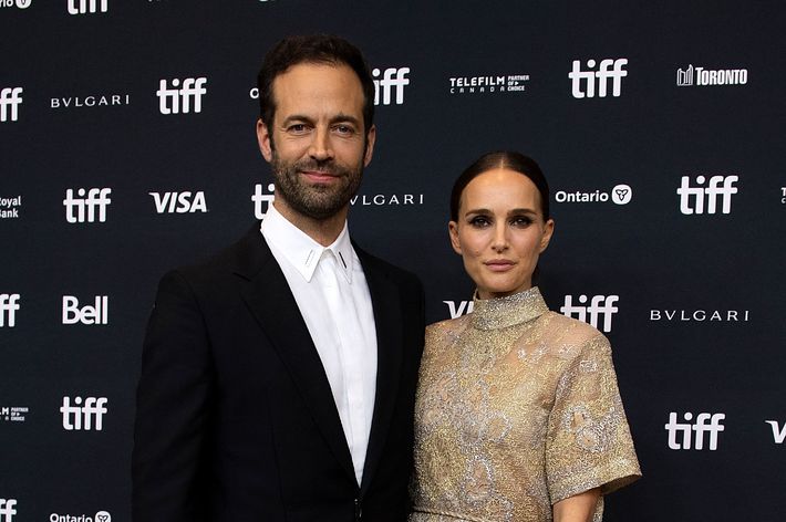 Benjamin Millepied and Natalie Portman pose together on the red carpet at the Toronto International Film Festival. Millepied wears a suit, Portman a chic dress
