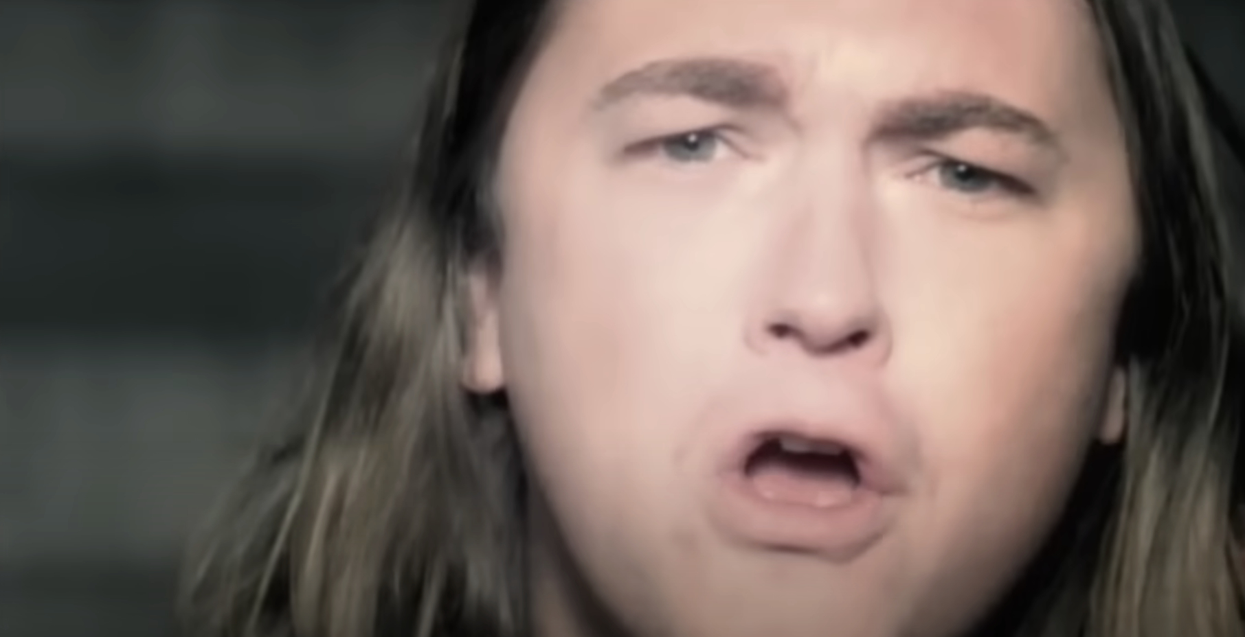 Edwin McCain singing passionately with a slightly open mouth and expressive face