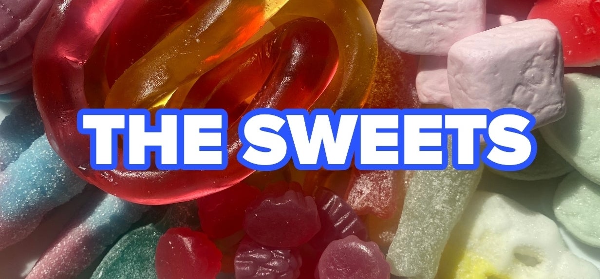 Various colorful gummy candies with the words &quot;THE SWEETS&quot; in bright blue bold text across the center