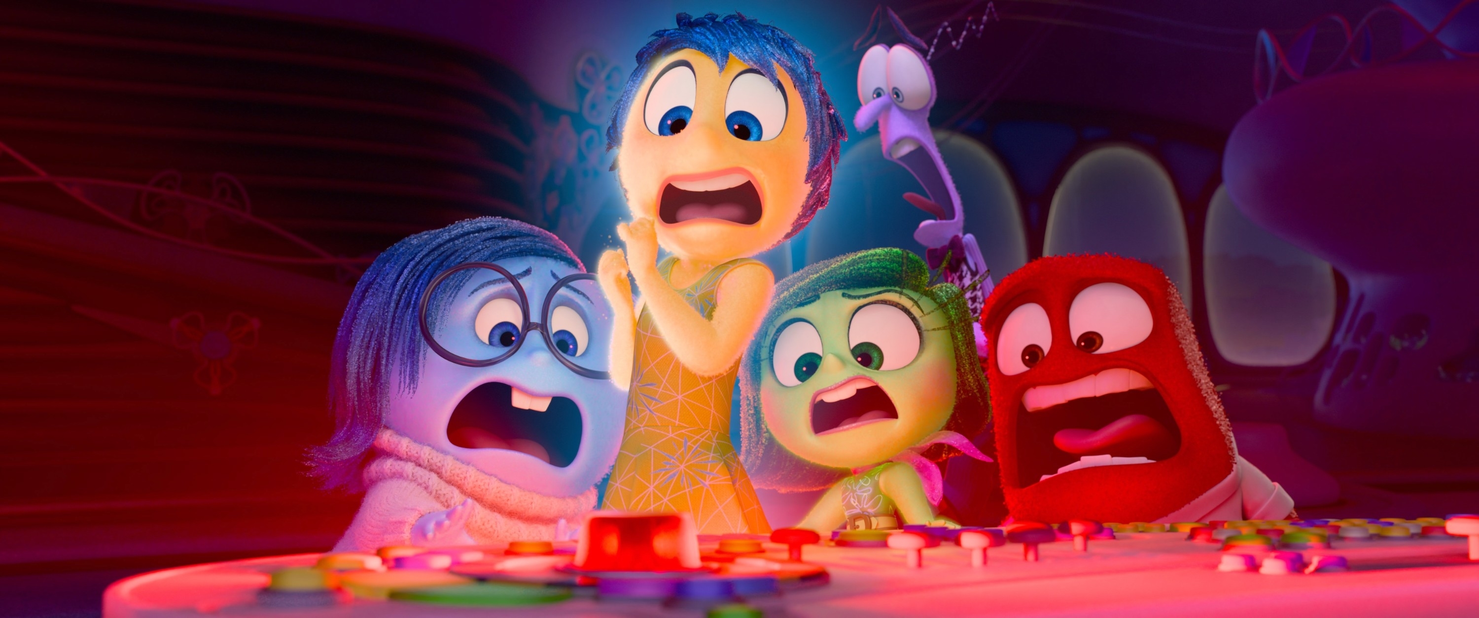 Sadness (glasses, voice: Phyllis Smith), Joy (green dress, voice: Amy Poehler), Disgust (green, voice: Liza Lapira), Fear (purple, voice: Tony Hale), Anger (red, voice: Lewis Black) from &quot;Inside Out 2&quot; look shocked while gathered around a control panel