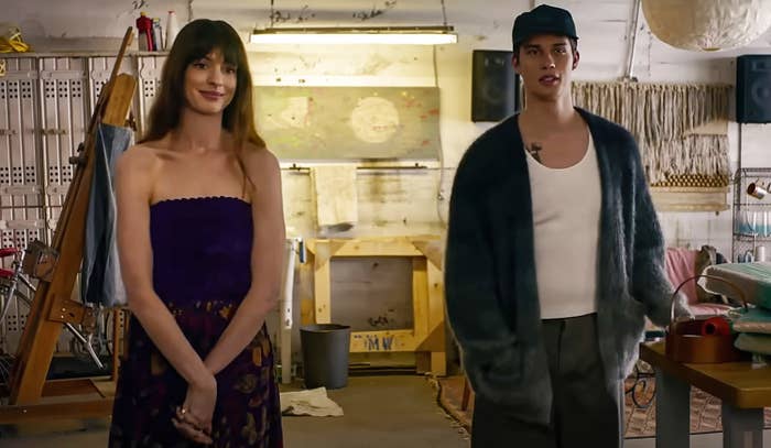 Anne Hathaway, Nicholas Galitzine standing next to one another in a scene from The Idea of You