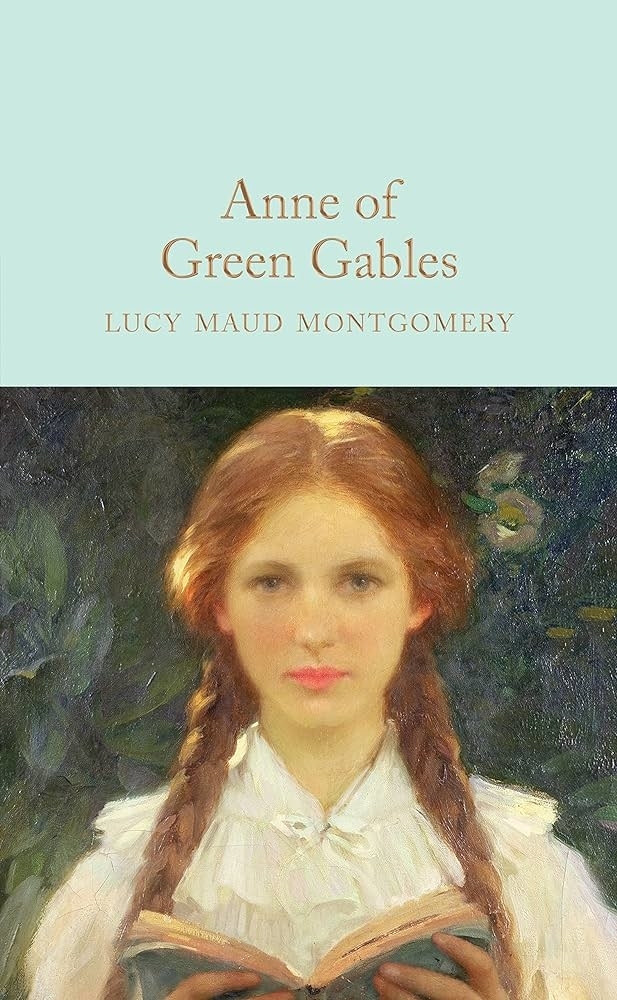 Cover of "Anne of Green Gables" by Lucy Maud Montgomery. It shows a young girl with red hair in braids, holding an open book, dressed in an old-fashioned blouse