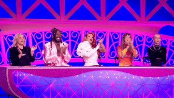 Alexis Michelle, Leland, Ts Madison, Yvie Oddly, and David Petruschin clapping and cheering while sitting at a judging panel on a brightly lit stage