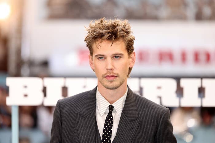 Austin Butler on the red carpet, wearing a pinstripe suit and polka dot tie