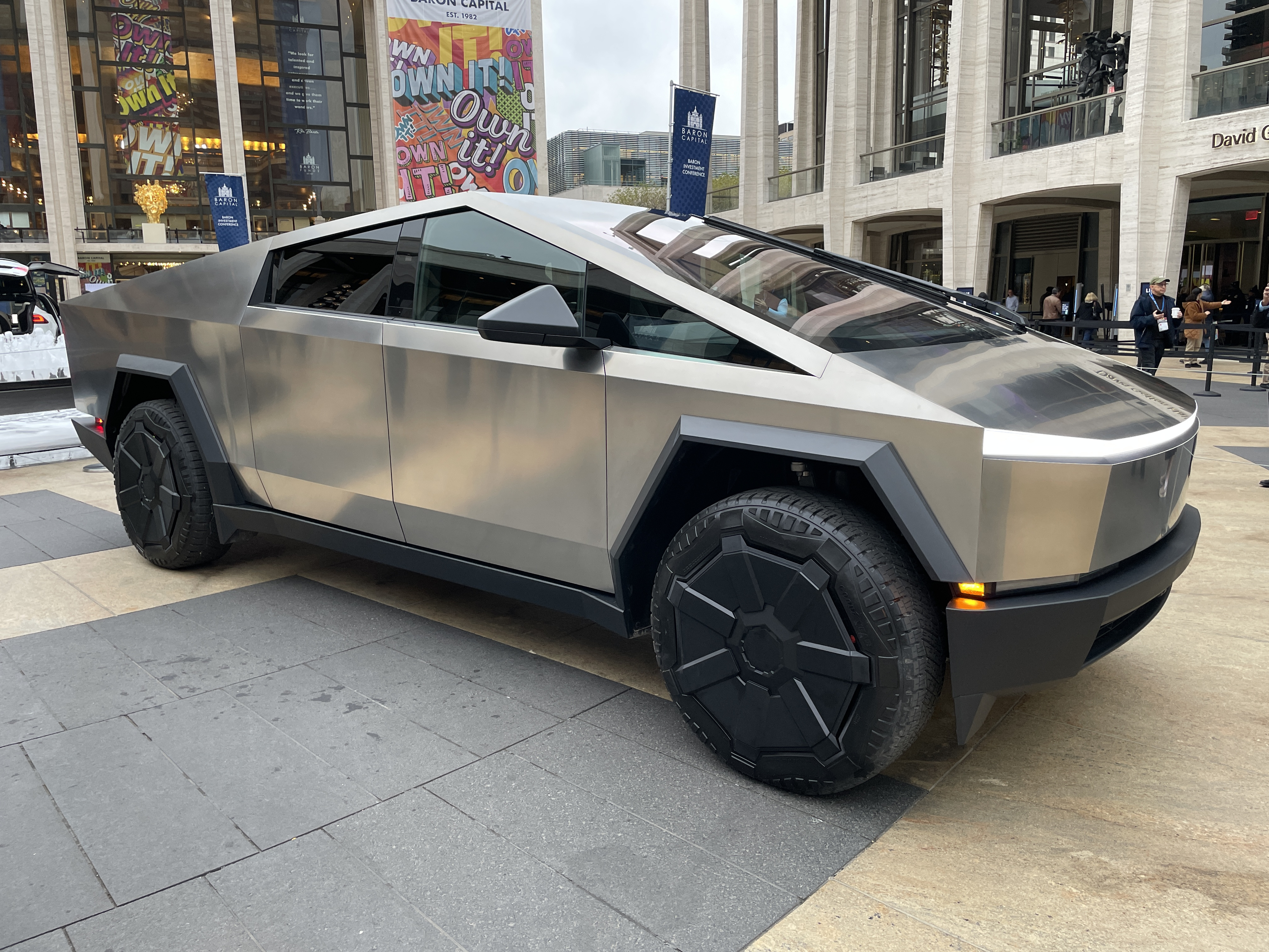 Tesla Cybertruck parked outdoors in an urban area. The vehicle features a futuristic, angular design