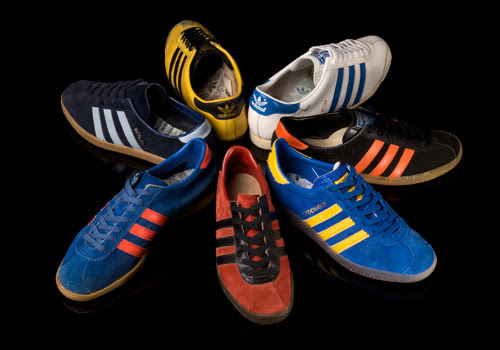 A variety of Adidas sneakers in different styles and designs arranged in a circular pattern