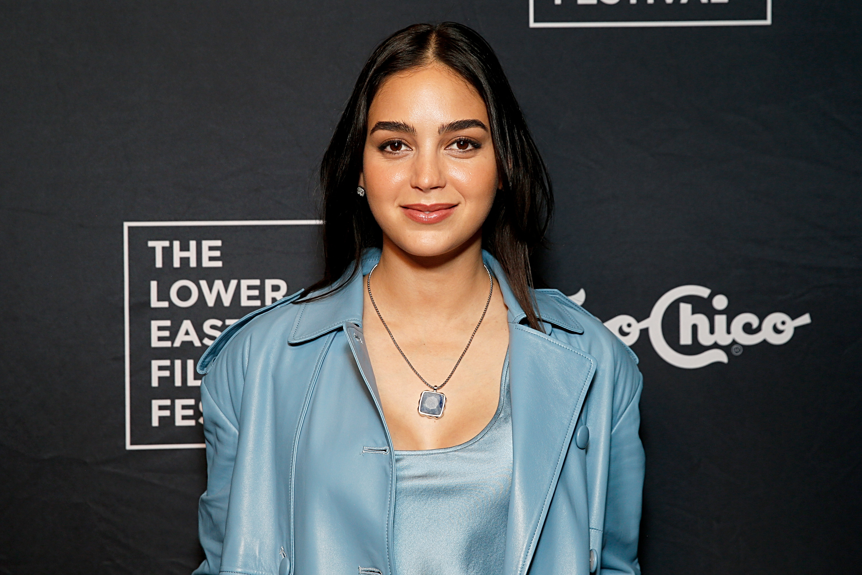 Melissa Barrera attends the Lower East Side Film Festival, wearing a satin top and leather jacket, with subtle jewelry